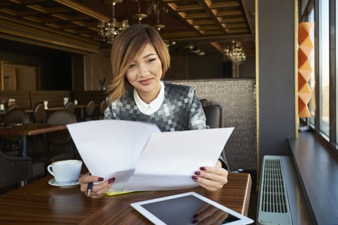 Woman Reading Reports